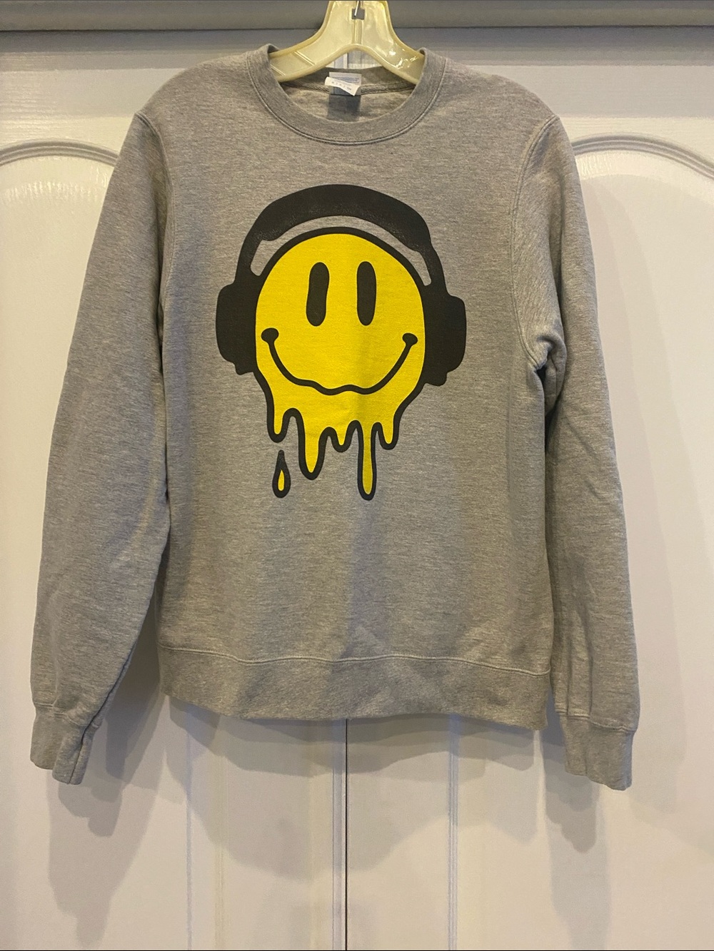 Gray Sweatshirt with Yellow Melting Smiley Graphic.